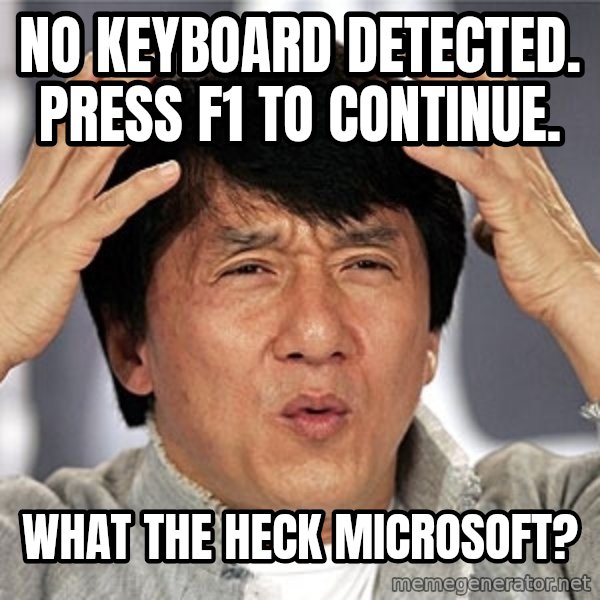 Jackie Chan meme: No keyboard detected. Press f1 to continue. / What the heck Microsoft?